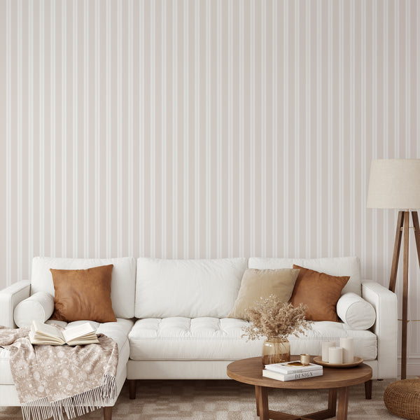 Neutral stripe wallpaper in beige and warm ivory with slim vertical lines, ideal for a minimalist nursery or modern bedroom accent wall.