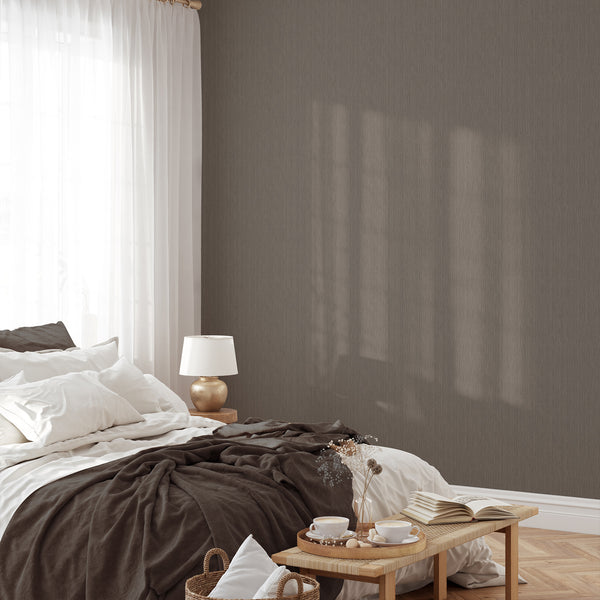 Close-up of taupe vertical textured wallpaper in a hallway setting, featuring irregular fine lines for a calm, neutral backdrop. This self-adhesive wallpaper is perfect for renters and decorators seeking a quiet yet stylish addition to modern spaces.