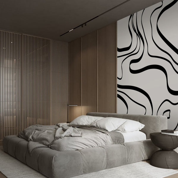 Black line art wallpaper with oversized flowing curves and irregular organic shapes, creating a graphic modern look for a living room wall.