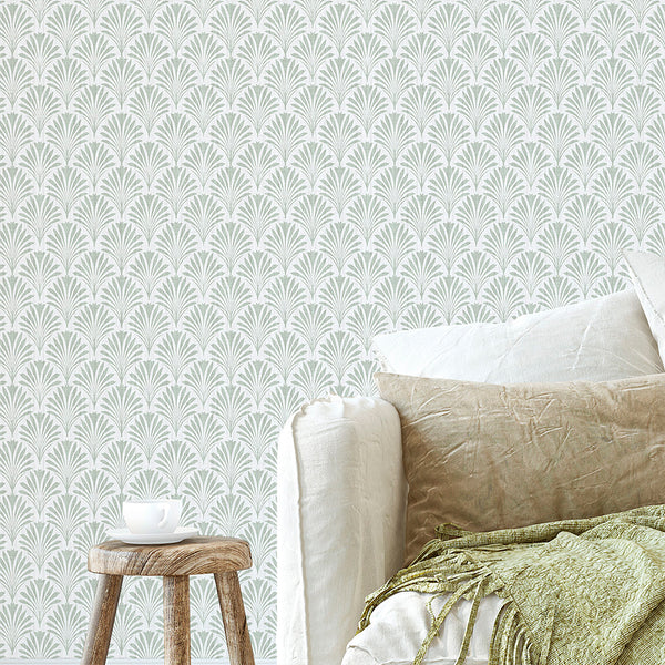 Small-scale fan or palm leaf wallpaper in muted sage green, featuring a dense repeat on a light neutral ground. The printed linen texture creates a refined look, ideal for entryways or living rooms. This removable peel and stick wallpaper is eco-friendly, made in the USA, and perfect for renters seeking a temporary decor option.