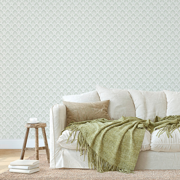 Muted sage green botanical leaves wallpaper with a dense, small-scale repeat on a light neutral ground. The subtle linen texture softens the design, perfect for creating a calming ambiance in nurseries or bedrooms. This pre-pasted wallpaper offers easy application and repositioning, ideal for decorators.