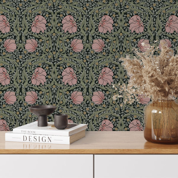 Detailed floral wallpaper featuring pink blooms and green leaves on charcoal, suitable for bold interiors.