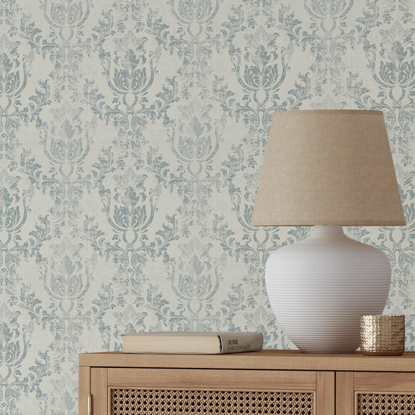 Create a vintage look with Light Blue Rococo wallpaper, featuring scrolling foliate motifs in light blue on an ivory ground. Suitable for a hallway or living room accent wall, this high-quality wallpaper offers easy application and removal.