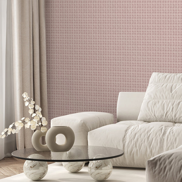 Vintage pink wallpaper featuring repeating floral damask motifs with a weathered textured finish for cottagecore bedroom and living room decor.