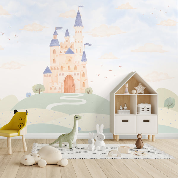 Blue castle wallpaper mural featuring a whimsical fairytale castle with pastel blue towers, rolling green hills, clouds and birds for a kids nursery.