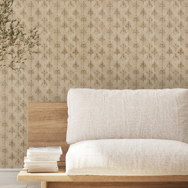 Vintage damask wallpaper with distressed gold brown ornaments on a warm neutral beige background, ideal for elegant French country home decor.