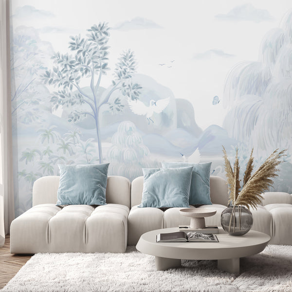 Elegant chinoiserie wall mural in pale blue and white with swans, trees, mountains and botanical details for nursery or living room decor.