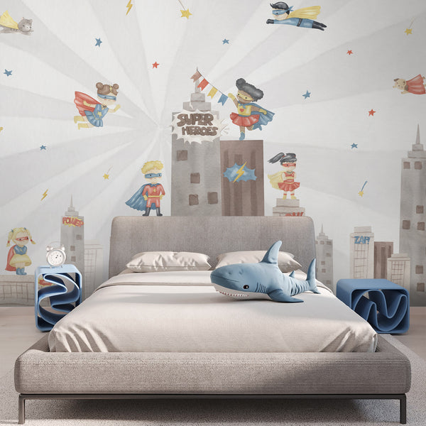 Watercolor superhero nursery wallpaper with flying boys and girls, city buildings, colorful capes, stars, and comic book details on a light background.