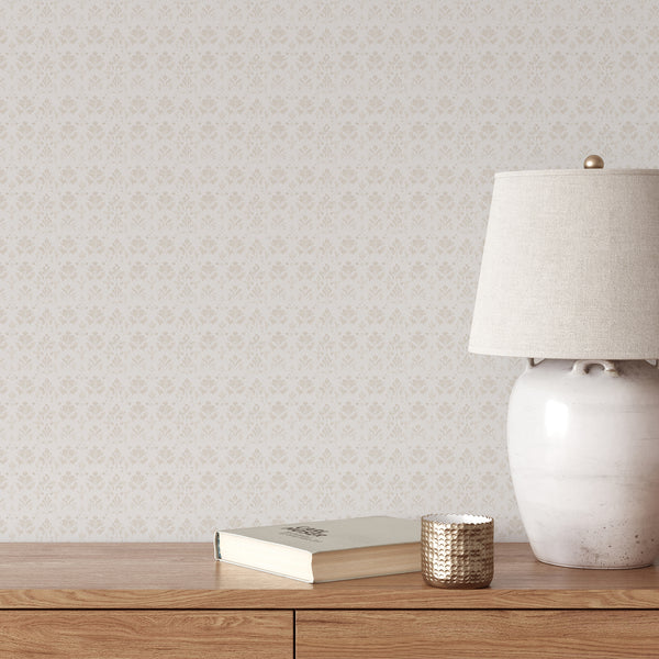 Beige floral damask wallpaper with stylized botanical motifs and a softly distressed texture on a warm white background for neutral bedroom decor.