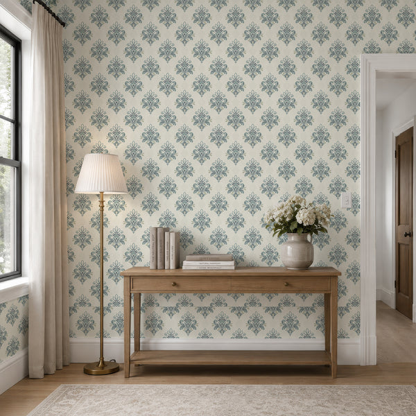 Elegant blue gray wallpaper featuring classic damask flourishes, symmetrical leaf patterns and soft sage accents for a refined bedroom or living room.