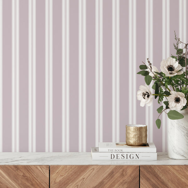 Dusty mauve and white striped wallpaper with wide vertical bands and delicate pinstripe details for modern bedrooms, nurseries, and living rooms.