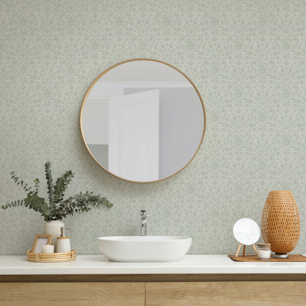 Vintage botanical damask wallpaper with pale sage green blossoms and scrolling leafy branches against a warm cream background for cottagecore bedroom decor.