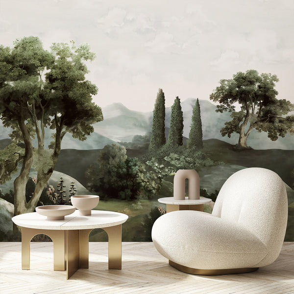 Dark green forest wallpaper showing large mature trees, distant hills, tall cypress forms, soft mist, and botanical details in a vintage landscape composition.
