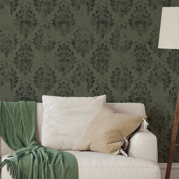 Dark green damask wallpaper with distressed medallions for a classic, aged look in living rooms or dining areas.