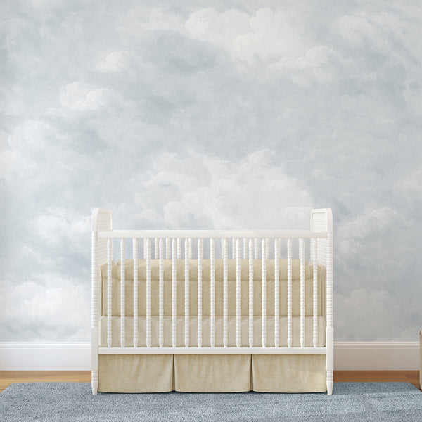 Light blue cloud wallpaper featuring soft white clouds and a dreamy watercolor sky, creating an airy backdrop for a peaceful nursery or bedroom.