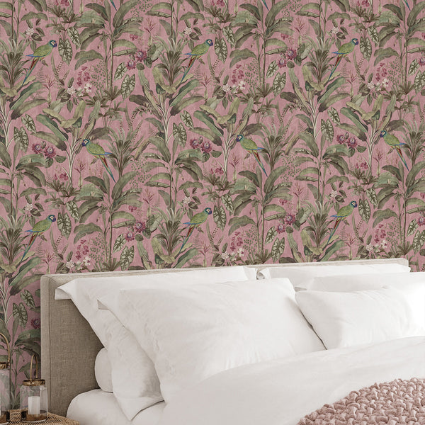 Dusty pink tropical wallpaper with green parrots, layered jungle foliage and vintage floral accents for an elegant bedroom or living room interior.