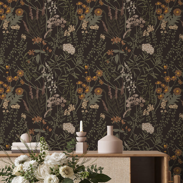 Moody Dark Floral Wallpaper with fine botanical illustrations in earthy tones on a near-black ground. Ideal for eclectic interiors, this removable wallpaper adds cozy depth and a statement look to bedrooms or studies, emphasizing eco-friendly benefits and easy usage.