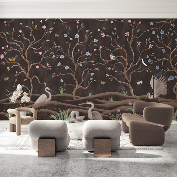 Dark brown chinoiserie wallpaper with graceful herons, flowering tree branches, colorful birds and butterflies in an elegant nature scene.
