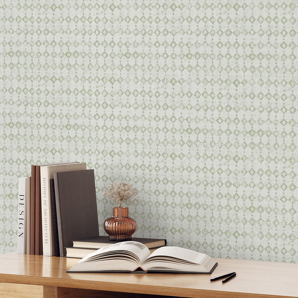 This wallpaper's distressed diamond lattice in sage green offers a soft, airy look for bathrooms and bedrooms. The pre-pasted design is eco-friendly and Made in the USA, perfect for decorators seeking a subtle, modern wall decor solution.