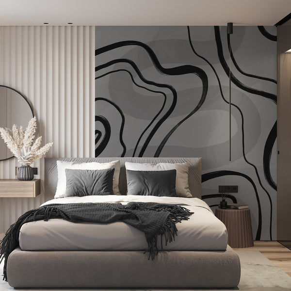 Minimalist wall mural featuring bold black curves across a medium gray textured background, creating a dramatic modern bedroom accent wall.