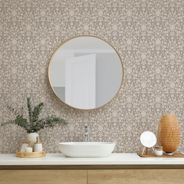 Vintage botanical damask wallpaper with stylized ivory flowers and curved leafy branches on a textured beige background for elegant bedroom wall decor.