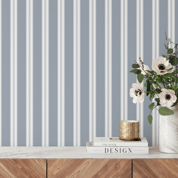 Dusty blue and white striped wallpaper with wide vertical bands and delicate pinstripe details, creating a refined look for bedrooms and living rooms.