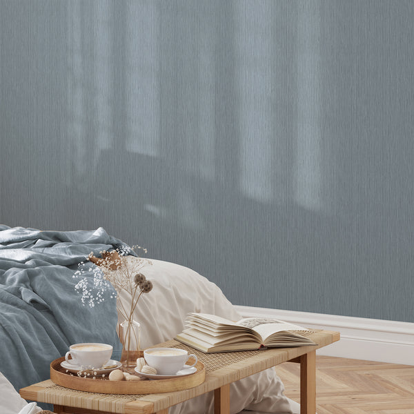 Textured wallpaper with a dusty blue palette, enhancing modern interiors with its calm, woven look.