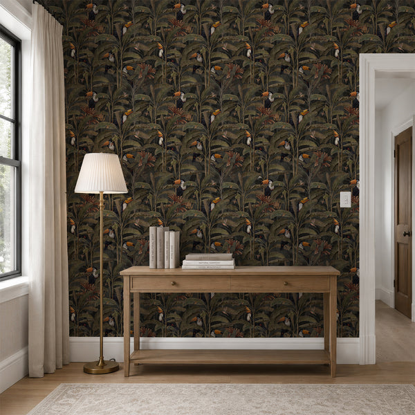 Dark green botanical peel and stick wallpaper with tropical birds, tall banana plants and rich jungle foliage for a dramatic bedroom accent wall.