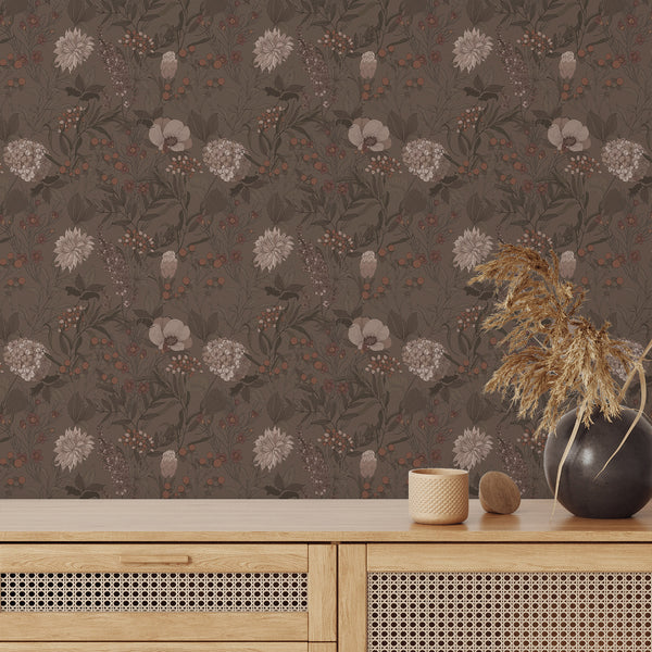 Taupe and warm brown floral wallpaper with terracotta accents, providing a moody, cozy backdrop for a bedroom or study. The finely drawn botanical elements create a vintage-inspired, engraved look.