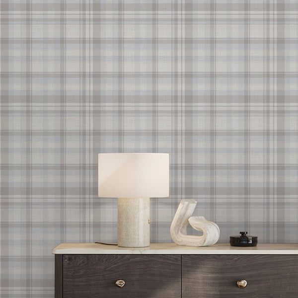 Pastel blue gray and beige plaid wallpaper with subtle horizontal and vertical checks, creating a light vintage-inspired pattern for Scandinavian decor.