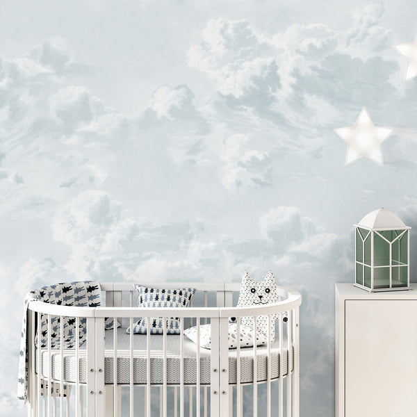 Dreamy neutral sky wallpaper with pale blue and white clouds, designed to create a soft and airy bedroom, nursery, or kids room accent wall.