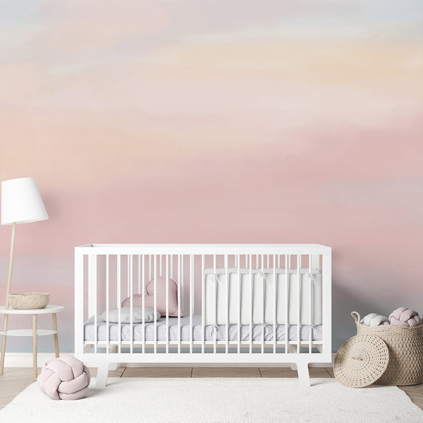 Dreamy watercolor wall mural featuring a soft pastel gradient of pink, peach, pale blue and cream for a minimalist nursery, bedroom or kids room.