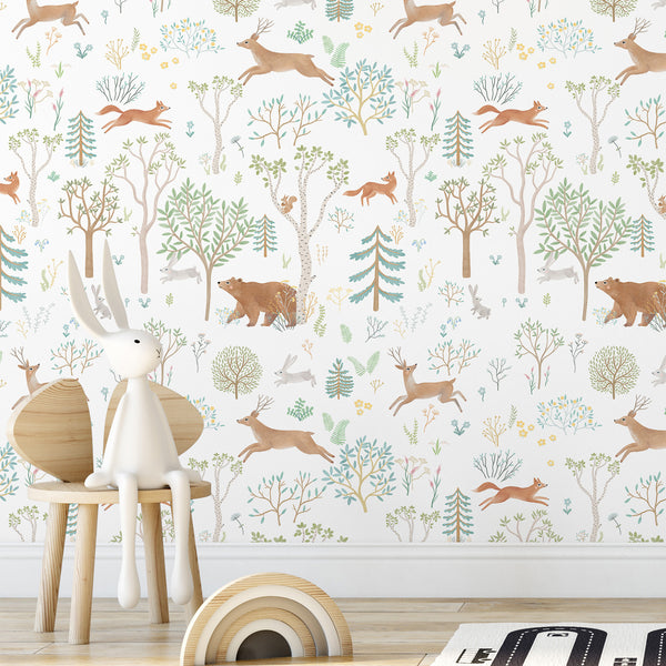 Hand-drawn forest animals like deer and foxes among trees in beige and green hues create a lively wallpaper perfect for nurseries or playrooms.