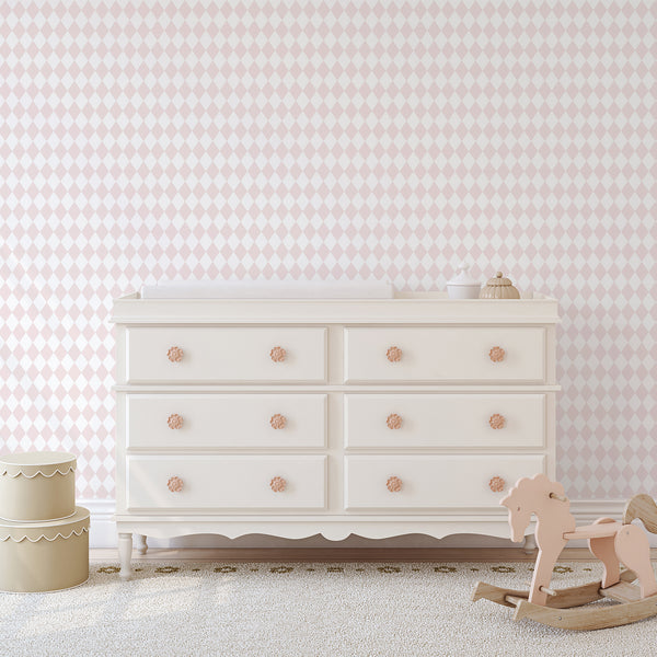 Pastel pink harlequin diamond wallpaper with a calm geometric texture. The eco-friendly material is made in the USA, ideal for adding a subtle pattern to hallways or tidy home offices.