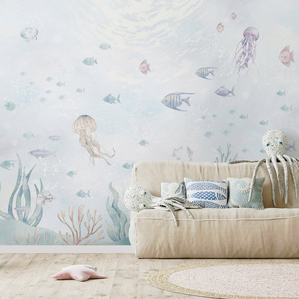 Soft watercolor ocean wallpaper with translucent jellyfish and kelp, creating a serene undersea scene. This self-adhesive mural is perfect for nurseries, adding a modern coastal touch to any space.