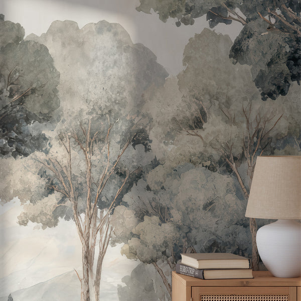 Expansive misty forest wall mural with muted greens and gray tones, offering a tranquil bedroom feature wall. This high-quality peel and stick wallpaper is ideal for renters and designers.