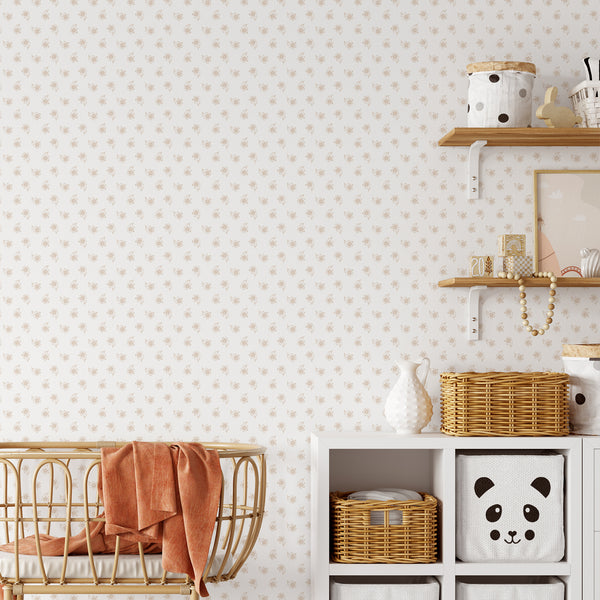Neutral nursery wallpaper with soft beige hand sketched flowers in a simple repeating pattern, creating a light and delicate look for a baby room.