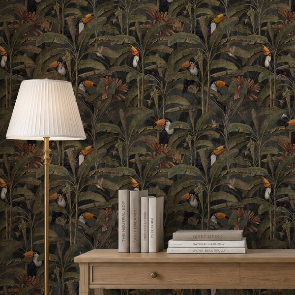 Dark tropical toucan wallpaper featuring colorful orange-beaked birds among large olive green banana leaves and dense jungle foliage on a charcoal background.