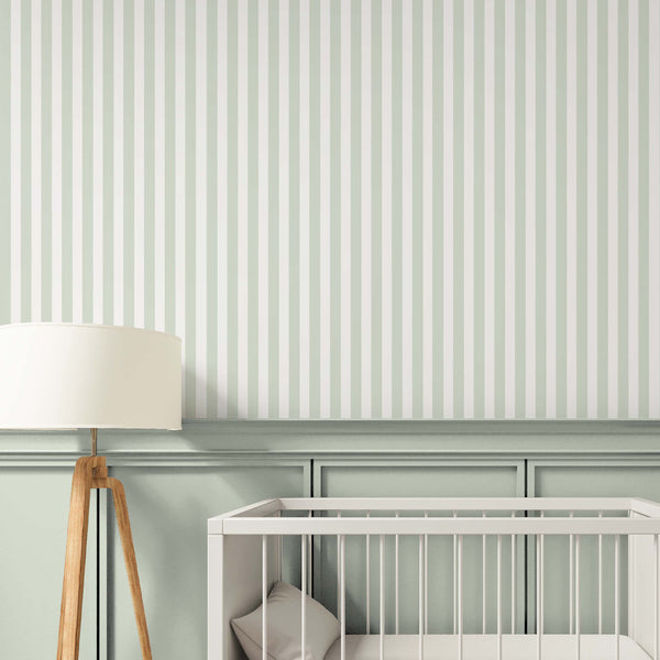 Vertical stripes in pale mint green and off-white on a bedroom wall enhance height and add subtle contrast. This classic design suits coastal decor and is made in the USA. Choose this high-quality removable wallpaper for a stylish accent wall.