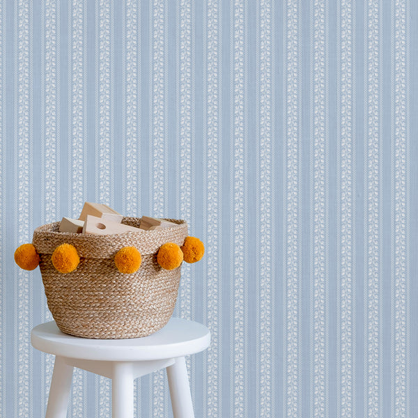 Soft blue floral stripe wallpaper with delicate white botanical vines creates a vintage cottagecore look, perfect for nurseries, bedrooms, bathrooms, and French country interiors.