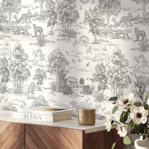 Classic gray French toile wallpaper featuring detailed countryside scenes with trees and big cats, perfect for adding a timeless look to French country or eclectic spaces. The removable wallpaper's intricate engravings provide a refined backdrop in sitting rooms or hallways.