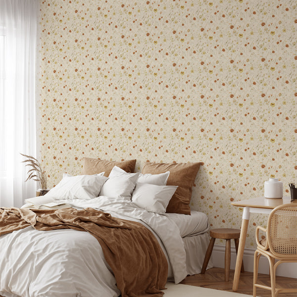 Vintage cottagecore floral wallpaper featuring scattered wildflowers and fine botanical stems on a warm beige background for bedroom or nursery decor.