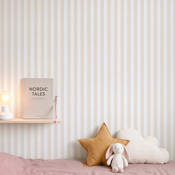 Close-up of beige vertical stripes wallpaper with a rhythmic narrow repeat, perfect for creating a calm, structured backdrop in kids, living or bedroom spaces. Made in the USA, this self-adhesive wallpaper is ideal for decorators seeking a neutral, elegant style.