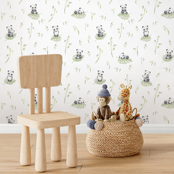 Botanical kids wallpaper featuring a watercolor panda, pale green tropical leaf and bamboo branches in a soft minimalist design for nursery decor.