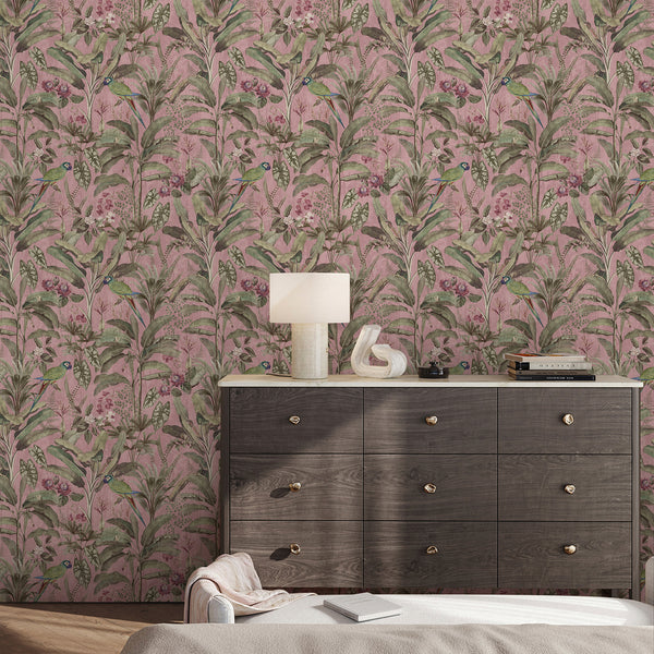 Botanical jungle wall mural with colorful parrots, green banana leaves, pink flowers and a textured rose pink background for statement wall decor.