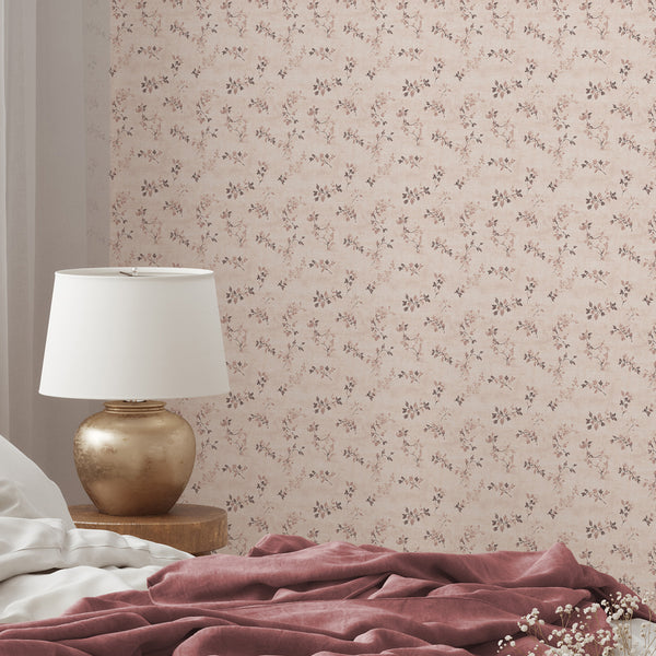 Soft blush wallpaper with floral vine motifs in muted tones, perfect for a cozy bedroom accent wall.