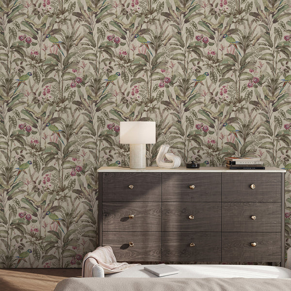 Jungle botanical wallpaper featuring colorful parrots, palm and banana leaves, pink flowers and detailed foliage in muted green and neutral tones.