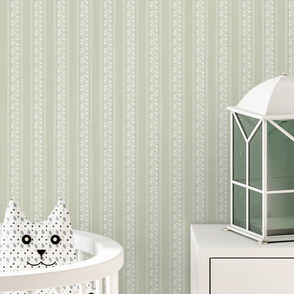 Cottagecore wallpaper in muted sage green with white floral illustrations, slim wavy stripe details, and a soft linen-inspired texture for cozy interiors.