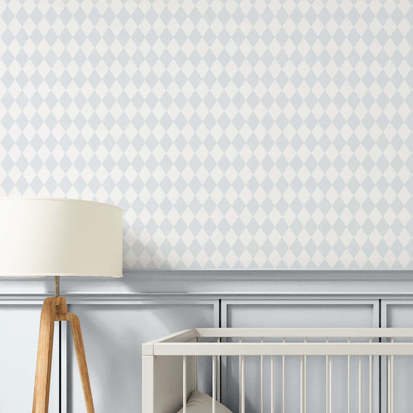 Pastel blue rhombus wallpaper featuring narrow diamond rows in powder blue and off-white, creating a harlequin pattern ideal for nurseries and kids' bedrooms. This removable peel and stick wallpaper is eco-friendly and made in the USA, offering a soft, matte finish with a subtle fabric-like grain, perfect for an accent wall.
