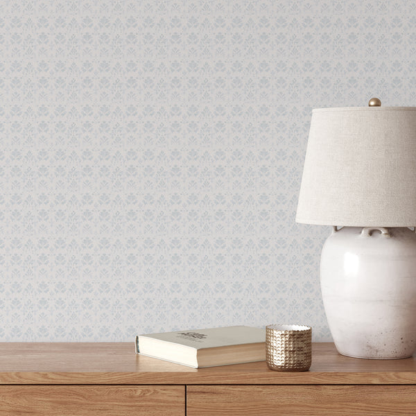 Blue floral damask removable wallpaper featuring a distressed vintage pattern on a soft white background, perfect for French Country and farmhouse interiors.